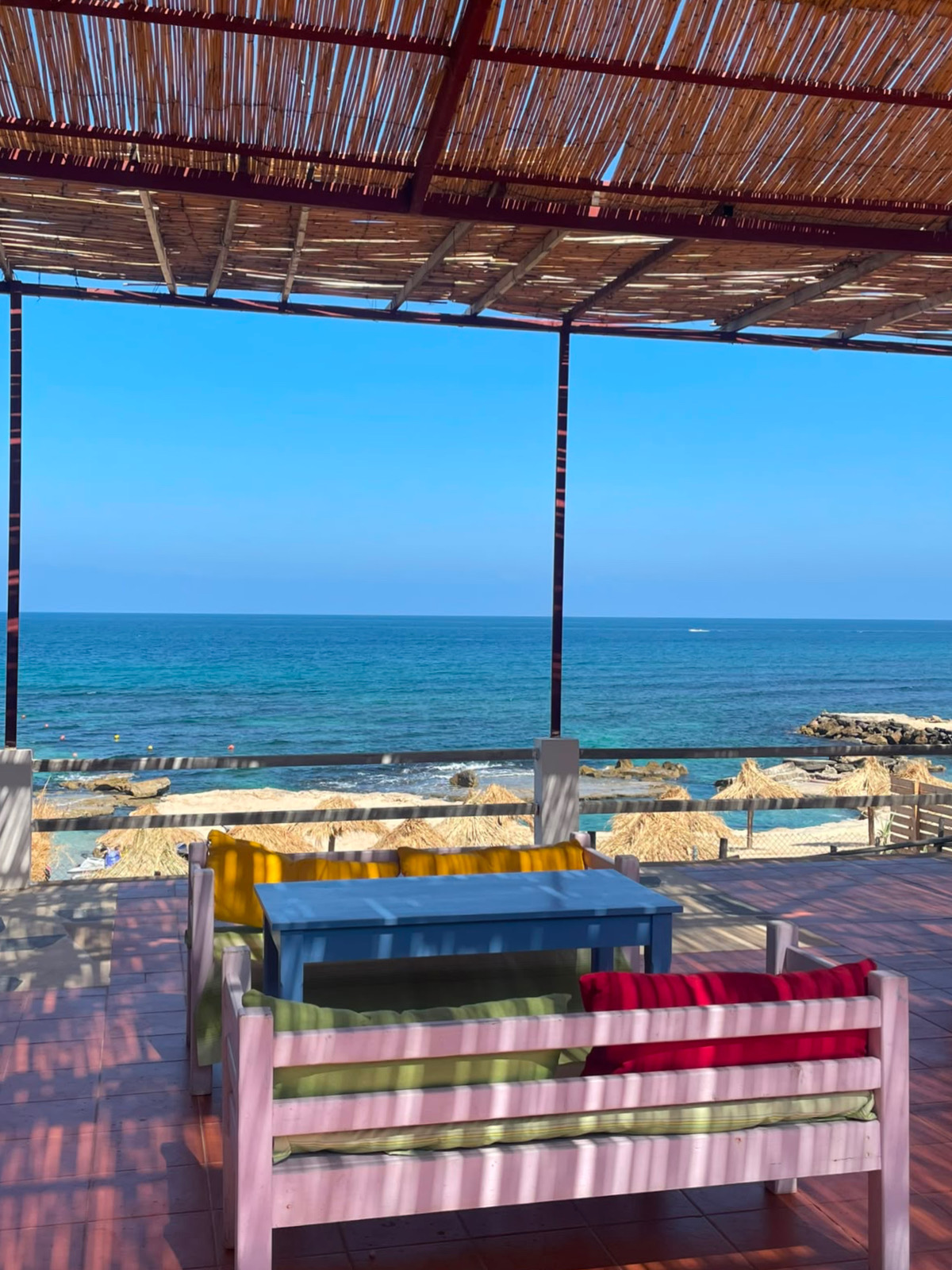 Side B restaurant terrace with colourful seating and sea view